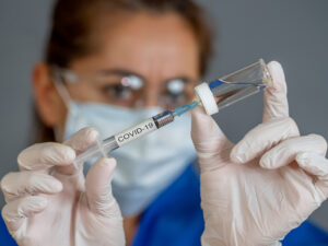 image-covid-19-coronavirus-vaccine-doctor-scientist-with-syringe-analyzing-virus-sars-cov-2