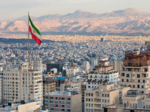 image-waving-iran-flag-above-skyline-of-tehran-at-sunset