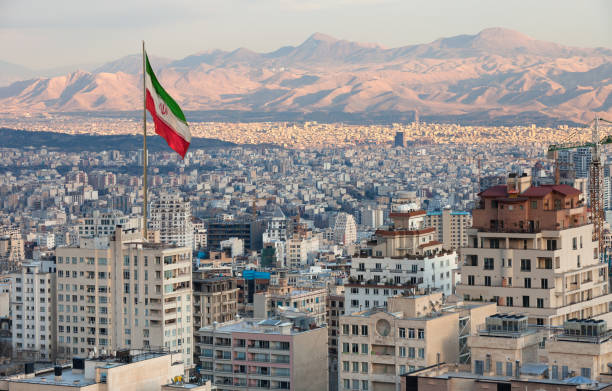image-waving-iran-flag-above-skyline-of-tehran-at-sunset